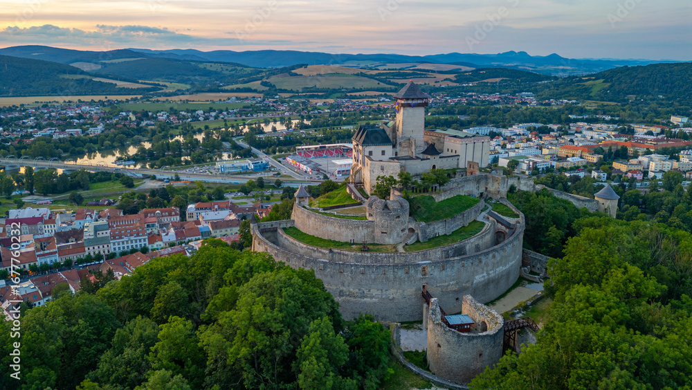 Fototapeta premium Sunset with Trencin castle overlooking the old town, Slovakia