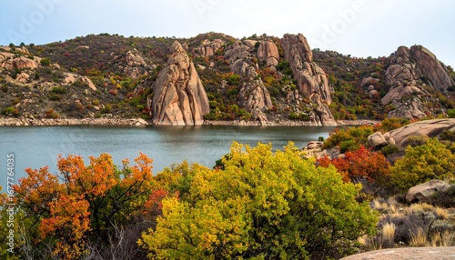Autumn landscape by a lake with rocky hills