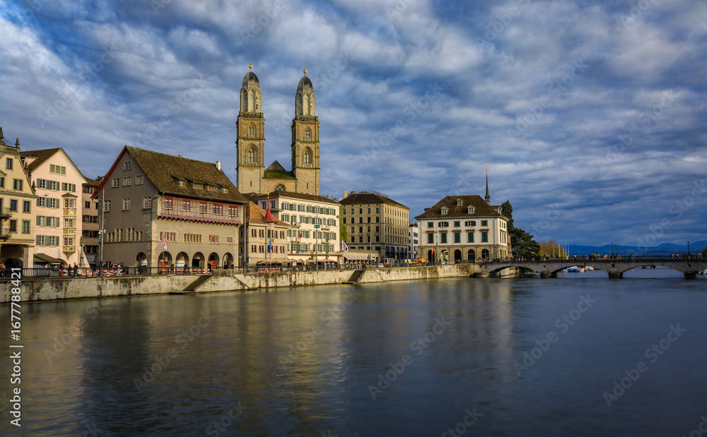 Fototapeta premium Zurich Cityscape with Limmat River and iconic Grossmunster cathedral Switzerland