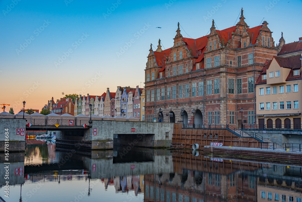 Fototapeta premium Waterfront with green gate in Gdansk during sunset, Poland