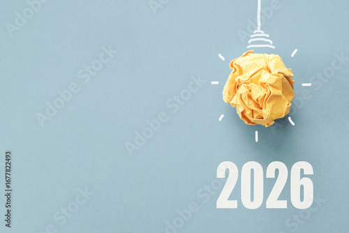 2026 with Yellow paper light bulb, innovative business vision and new year resolution concept