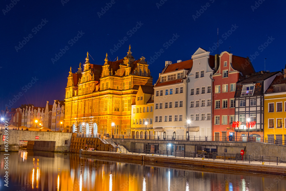 Fototapeta premium Waterfront with green gate in Gdansk during sunset, Poland