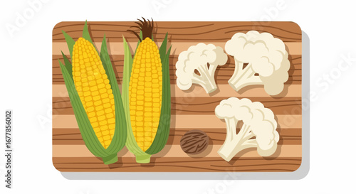 An overhead view of fresh corn on the cob, cauliflower florets, and a whole nutmeg on a wooden cutting board.