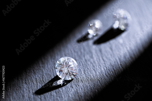 Closeup of sparkling diamonds with shadows on dark background, symbol of luxury, jewelry, wealth, romance, and elegance, perfect for fashion, wedding, advertising, and creative projects.