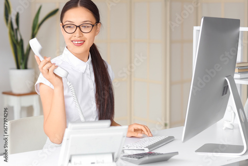 Young female receptionist i...