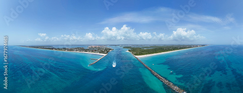 Aerial panorama view of boat heading to sea in Fort Pierce Inlet on the Treasure Coast of Florida in St. Lucie County