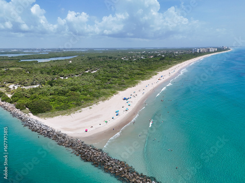 Tourists and locals enjoying a beach day at Fort Pierce Inlet State Park on the Treasure Coast of Florida in St. Lucie County