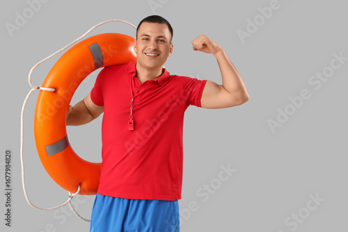 Happy male lifeguard with r...