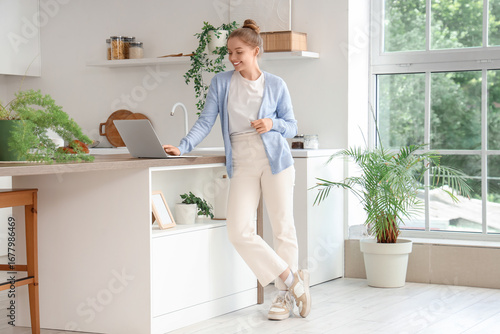 Young woman using modern la...