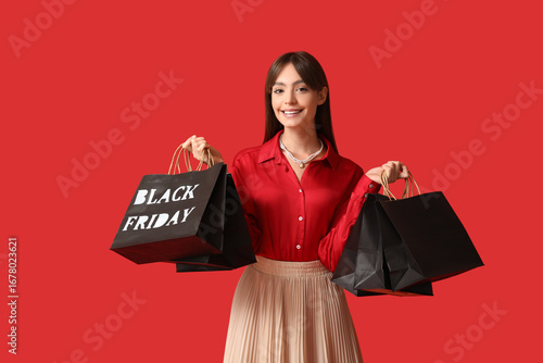 Smiling young woman holding...