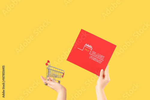 Woman holding card and toy ...