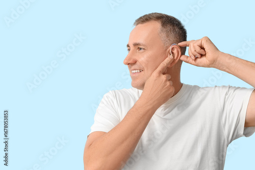 Mature man with hearing aid...