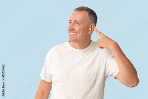 Mature man pointing at hear...