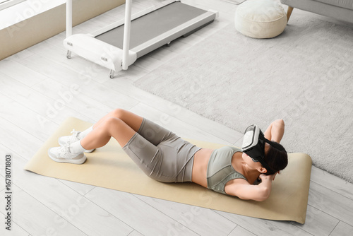 Sporty young woman in VR gl...