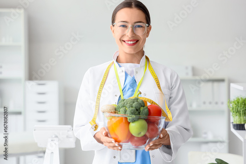 Female nutritionist with healthy food in office