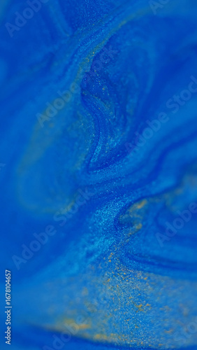 Blur glitter. Liquid shimmer. Defocused blue yellow color marble texture shiny water fluid enamel floating on abstract background.