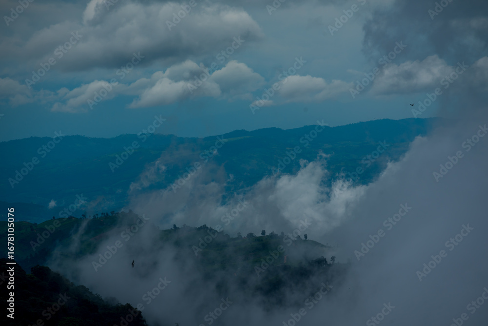 Obraz premium Amazing landscape fog mountain clouds scenery. Beautiful Mountain landscape foggy windy mountain range green landscape asian farm. Landscape mountain green field meadow white cloud blue sky sunrise