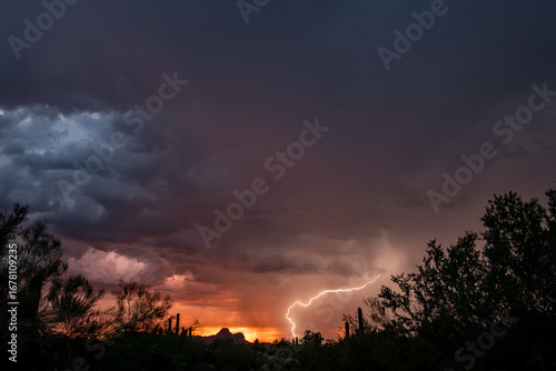 Lightning at sunset in the sonoran desert with colorful clouds