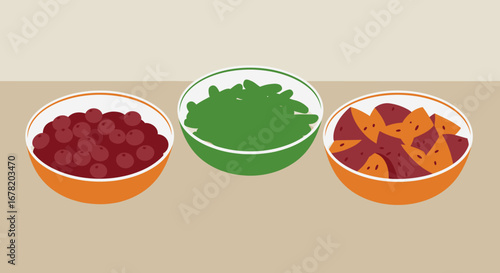 Three bowls hold cranberries spinach  cut sweet potatoes