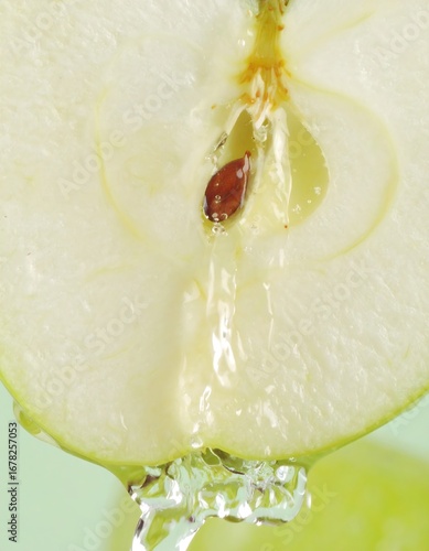Close-up of a sliced green apple with water droplets