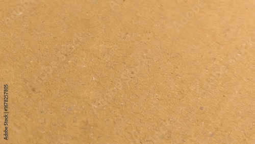 Background of brown kraft paper or cardboard texture. Abstract pattern of beige rough carton, old paper sheet, parchment or papyrus surface,