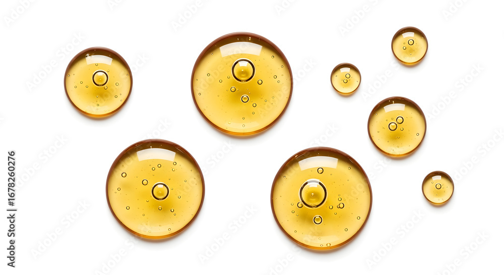 Fototapeta premium Discover luxurious golden serum drops with tiny bubbles, perfect for beauty and skincare advertising.