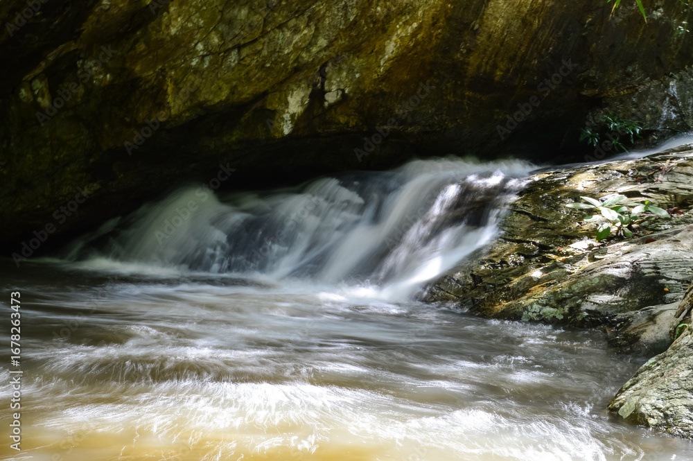 Naklejka premium Rapids and streams in Huay Kaew Waterfall in the rainy season at Doi Suthep-Pui National Park,Chiang mai, Northern Thailand.