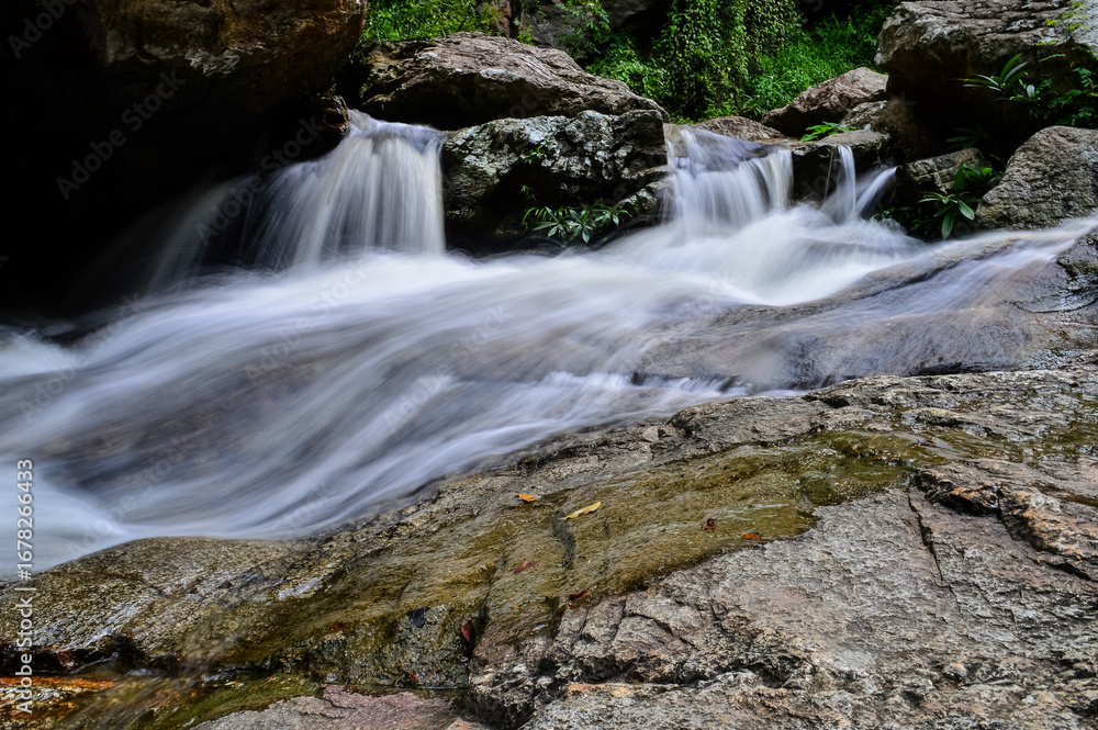 Fototapeta premium Rapids and streams in Huay Kaew Waterfall in the rainy season at Doi Suthep-Pui National Park,Chiang mai, Northern Thailand.