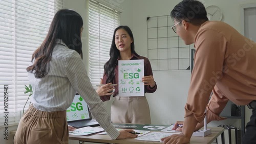 Businesswoman showing esg banner to colleague in office