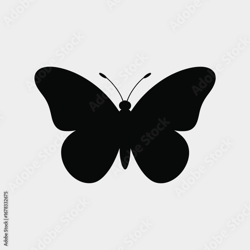 Black butterfly silhouette against a light gray background insect wings