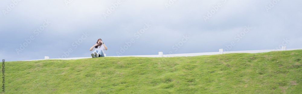 Obraz premium Relax and wellness concept with woman sit on road in garden and mountain background at chiangmai thailand in raining season