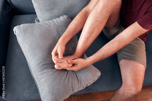 Man with ankle and foot pain at home.