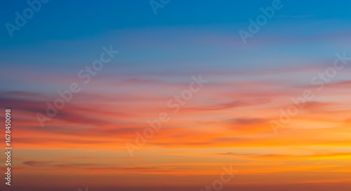 A beautiful, vibrant sunset sky with clouds in a smooth gradient of orange, pink, and blue