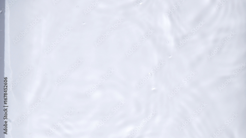 Obraz premium Blurred background of water texture with natural light. Abstract backdrop of clean water. Concept of blurry, sunny day, summer, minimal for print, wallpaper, texture. Blur ripples water surface.