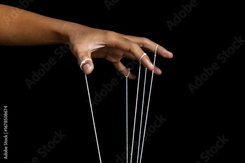 Cuadro en lienzo male puppeteer hand with strings isolated on black background
