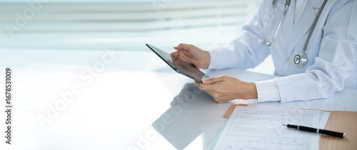 Male doctor professional reading data medical research and study medical report in room office at hospital. wide view. copy space.