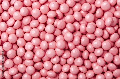 A full frame close-up of small pink candy coated chocolates