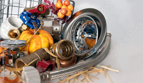 Plumbing tools with small pumpkins and festive Thanksgiving elements.