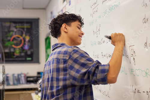 Wallpaper Mural Teen student writing equation on whiteboard in classroom Torontodigital.ca
