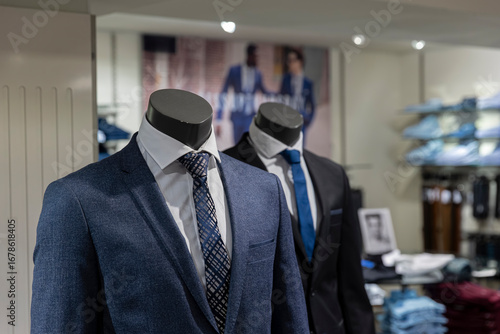Canvas Print Professional menswear suits and ties displayed on mannequins in clothing store