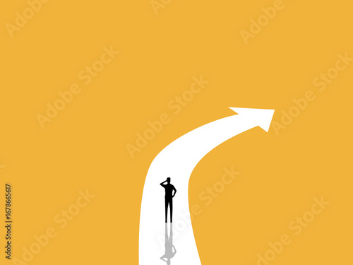 businessman stands on a curved road following the arrow