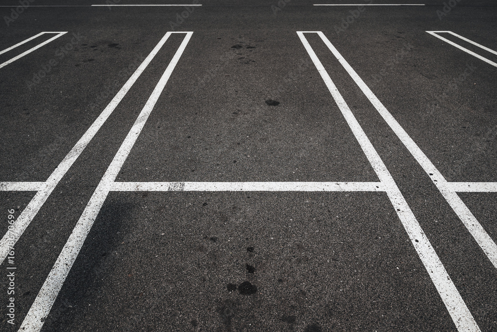 Parking lot, road marking white lines on asphalt surface as abstract pattern Parking lot, road marking white lines on asphalt surface as abstract pattern