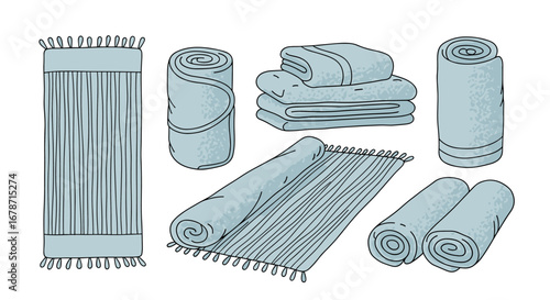 A collection of light blue towels neatly folded and rolled for bathroom use