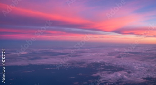 Fototapeta Naklejka Na Ścianę i Meble -  Aerial view of clouds illuminated by a vibrant pink and purple sunset