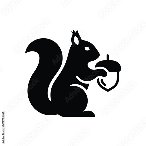 Vector illustration of squirrel silhouette, holding an acorn in its paws