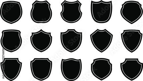 Fifteen black shield shapes with white outlines arranged in rows, showcasing various heraldic and security badge designs.
