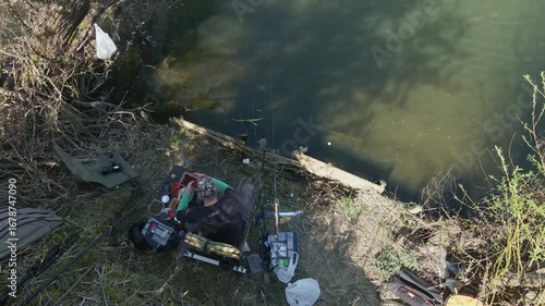 a man fishing on the river throws a hook