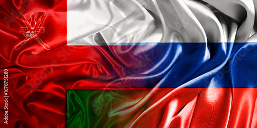 The national flags of Russia and Oman are combined into one and placed side by side on a fluttering cotton background. Flags.