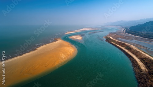 Aerial view of a river delta, sandy shoals, and coastline