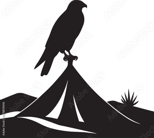 Black silhouette of a falcon perched on a tent in a desert landscape bird raptor